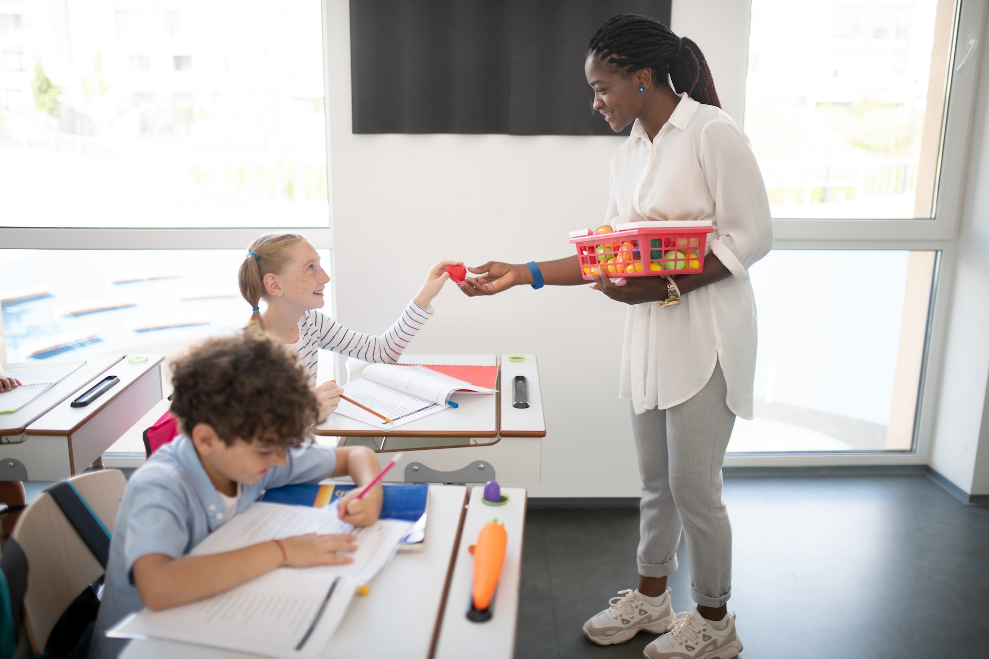 Girl getting a prize from teacher