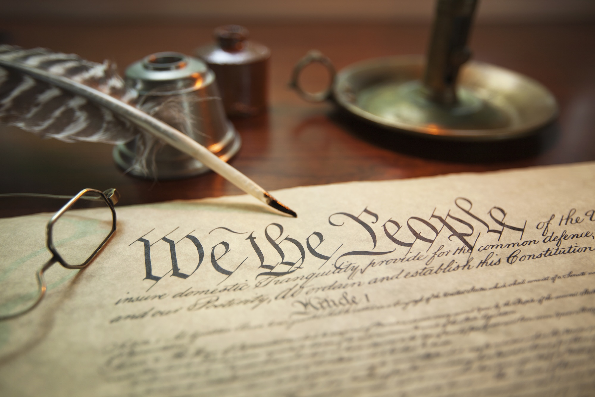 United States Constitution with quill, glasses and candle holder